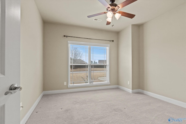 carpeted spare room featuring ceiling fan