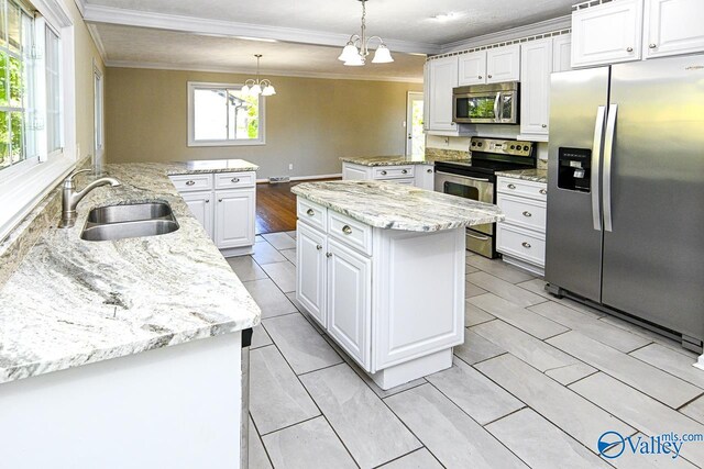 kitchen with sink, kitchen peninsula, decorative light fixtures, white cabinetry, and appliances with stainless steel finishes