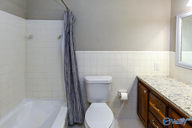 full bathroom featuring shower / tub combo with curtain, vanity, tile walls, tile patterned floors, and toilet