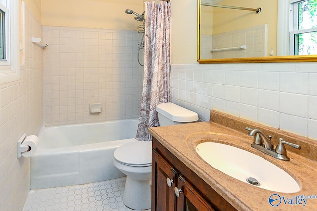 full bathroom with shower / bath combination with curtain, vanity, toilet, tile walls, and tile patterned flooring