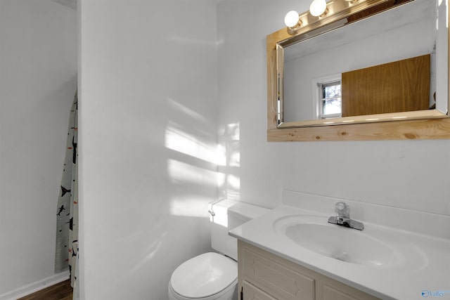 bathroom featuring toilet and vanity