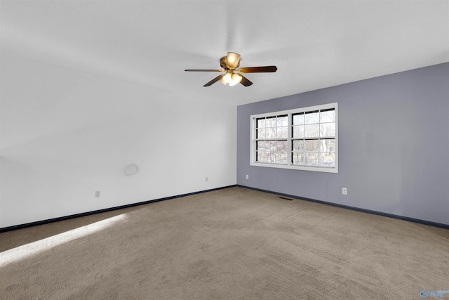 unfurnished room with ceiling fan and light colored carpet