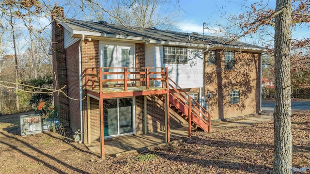 rear view of house with a wooden deck