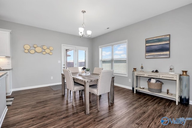 dining space with an inviting chandelier and dark hardwood / wood-style floors