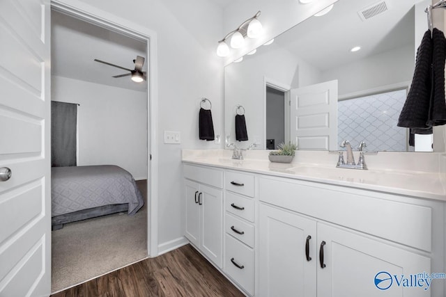 bathroom featuring wood-type flooring, vanity, and ceiling fan