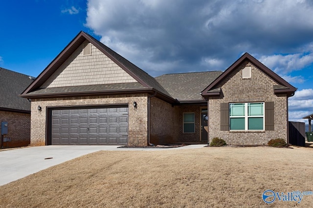 view of front of house featuring a front yard and a garage