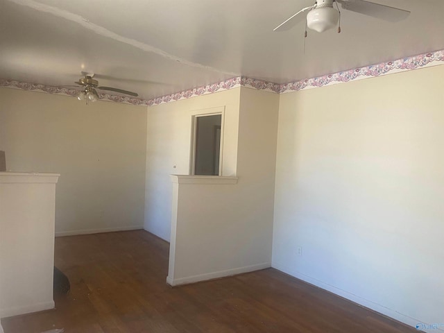 spare room featuring ceiling fan, baseboards, and wood finished floors