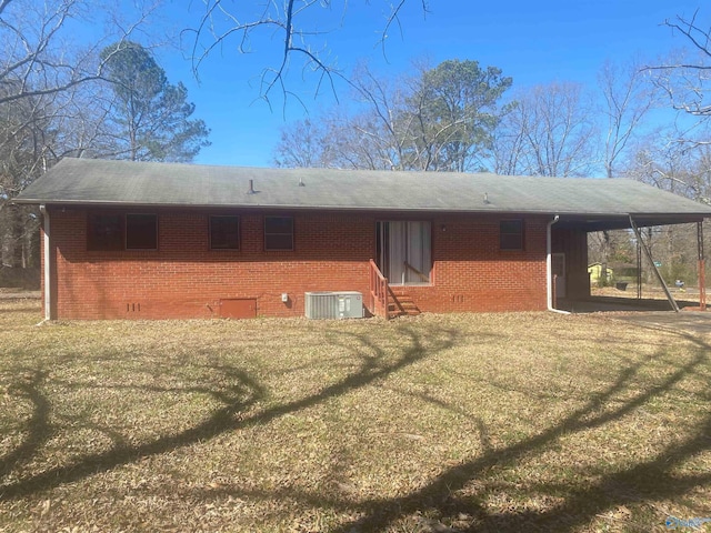 rear view of property featuring a carport, entry steps, brick siding, and cooling unit