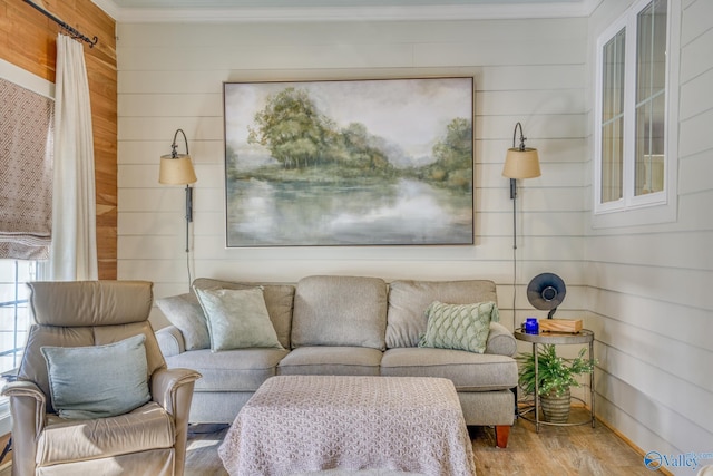 living room with crown molding, wood-type flooring, and wooden walls