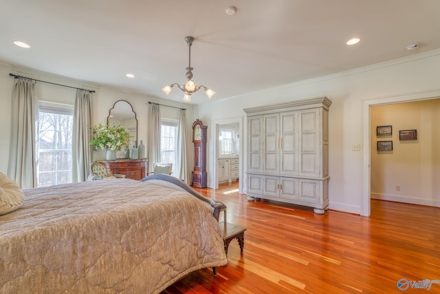 bedroom with light wood-type flooring, an inviting chandelier, ornamental molding, and multiple windows