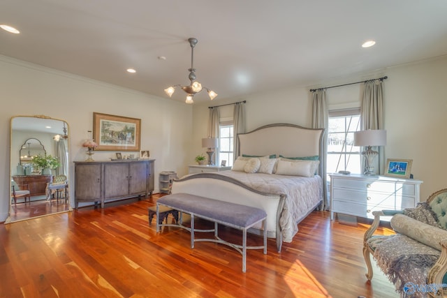 bedroom with wood-type flooring, a notable chandelier, and ornamental molding