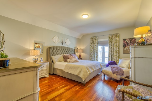 bedroom with lofted ceiling and hardwood / wood-style flooring