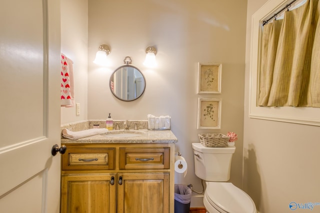 bathroom featuring toilet and vanity