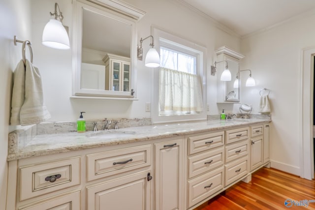 bathroom with vanity, wood-type flooring, and crown molding