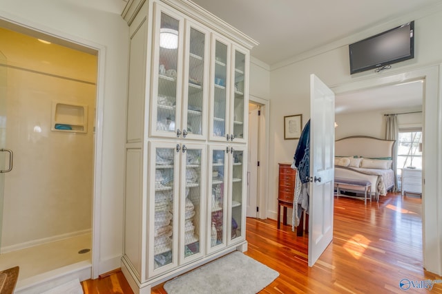 doorway featuring hardwood / wood-style flooring and ornamental molding