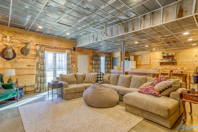 interior space featuring wood walls and concrete flooring