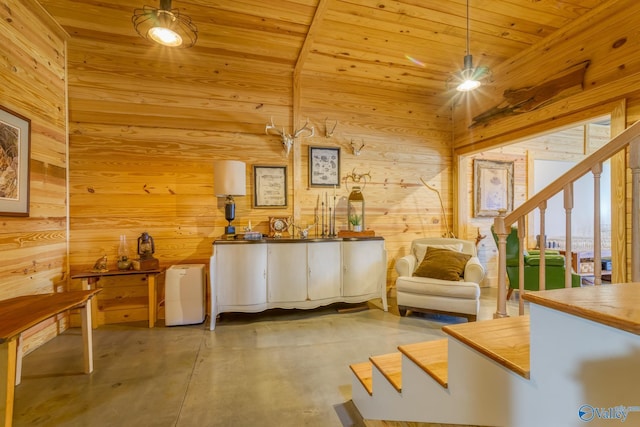 unfurnished room featuring vaulted ceiling, wood ceiling, and wooden walls