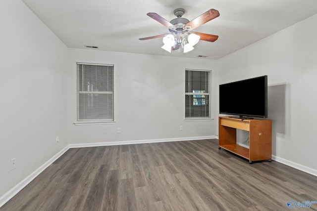 unfurnished living room featuring hardwood / wood-style flooring and ceiling fan