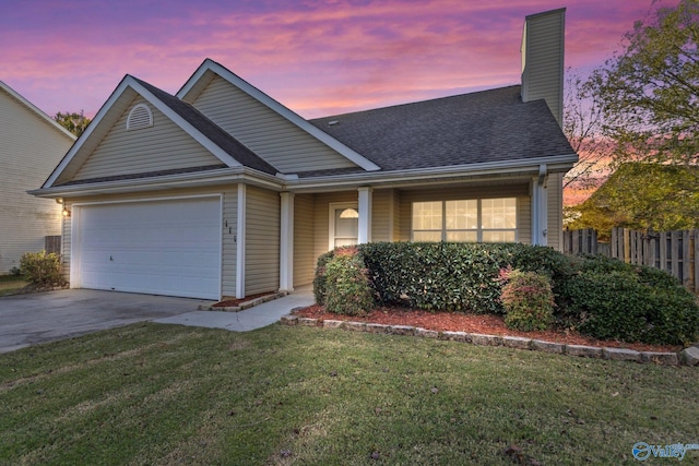 view of front of property featuring a garage and a yard