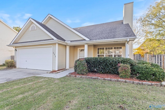 view of front of property featuring a garage and a front lawn