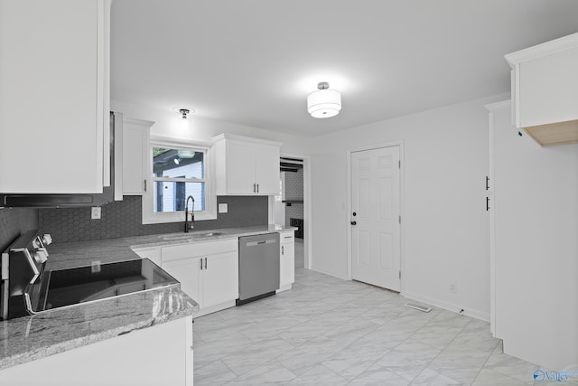 kitchen with white cabinets, light stone counters, sink, dishwasher, and range