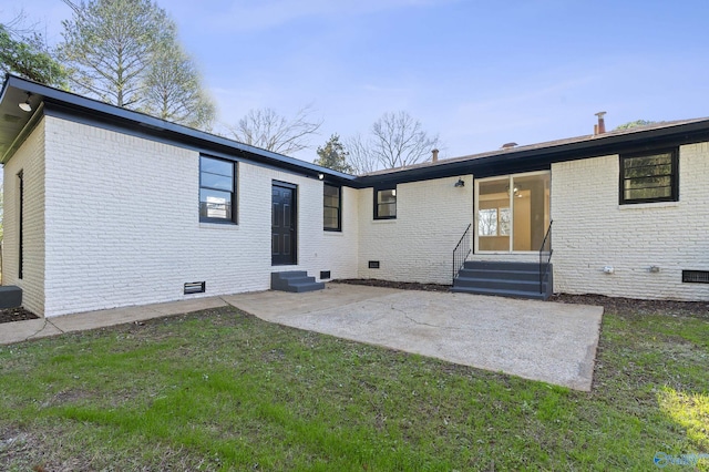 rear view of property with a patio area and a lawn