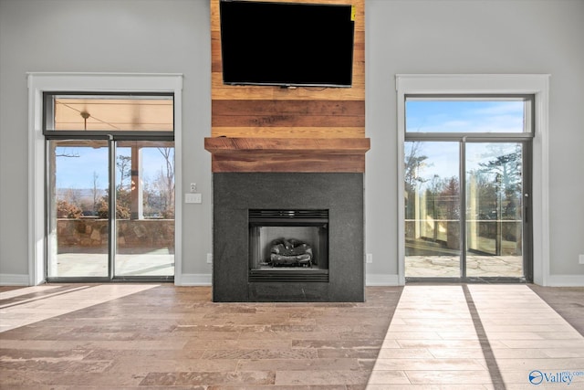 unfurnished living room featuring wood-type flooring and a wealth of natural light