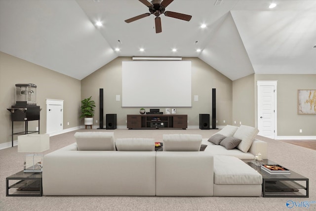 cinema featuring ceiling fan, lofted ceiling, and light carpet