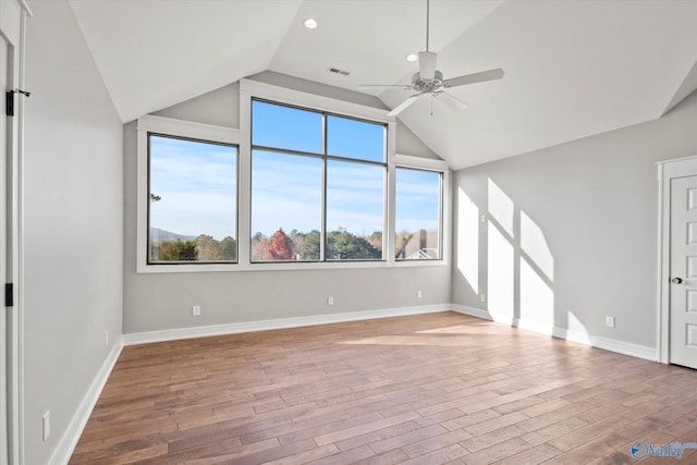 interior space with ceiling fan, light hardwood / wood-style floors, and vaulted ceiling