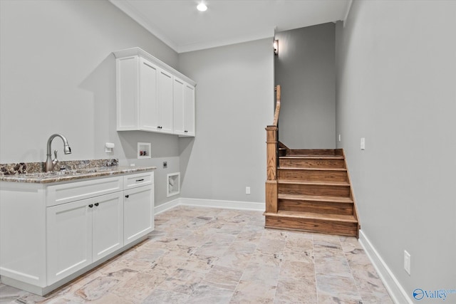 laundry room featuring hookup for an electric dryer, washer hookup, cabinets, ornamental molding, and sink