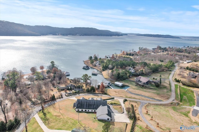 drone / aerial view featuring a water and mountain view