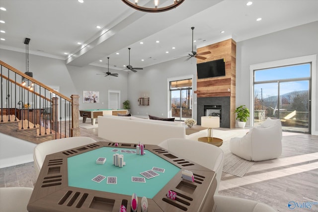 living room with a fireplace, light wood-type flooring, and plenty of natural light