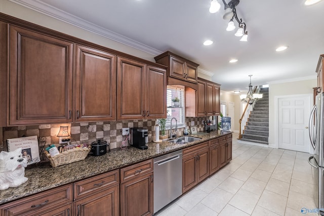 kitchen with light tile patterned floors, ornamental molding, a sink, appliances with stainless steel finishes, and backsplash