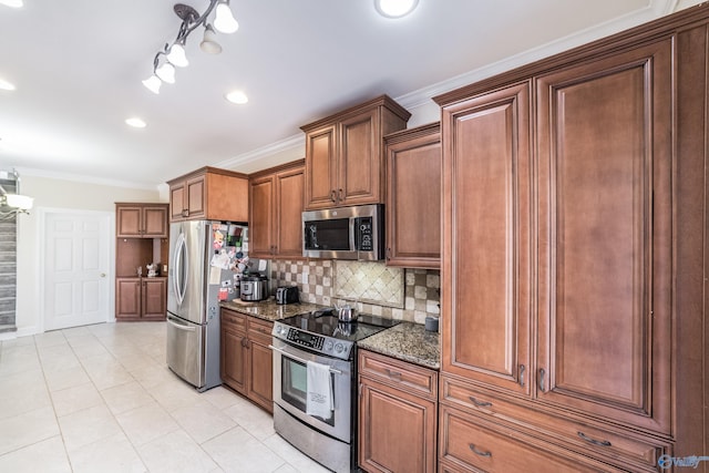 kitchen with backsplash, crown molding, dark stone counters, light tile patterned floors, and stainless steel appliances