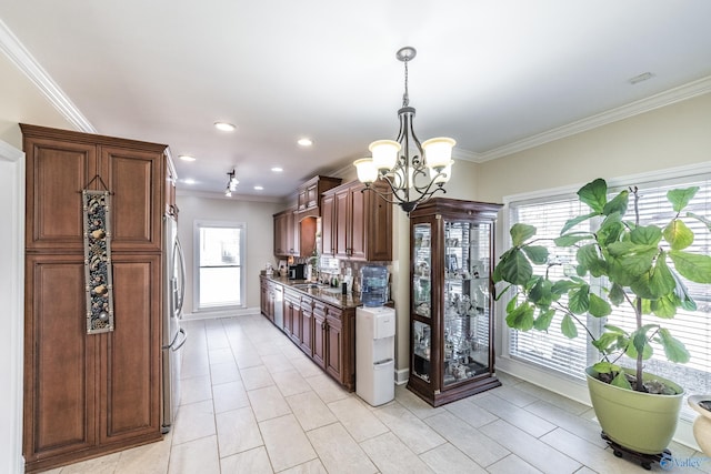 kitchen featuring plenty of natural light, a notable chandelier, and crown molding