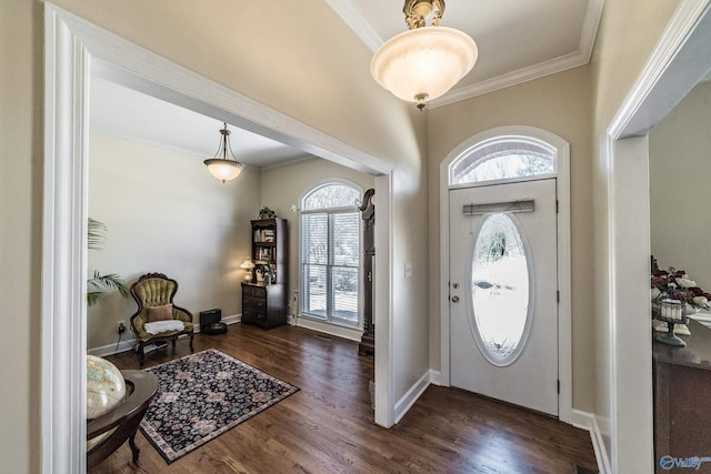 foyer with crown molding, plenty of natural light, and wood finished floors