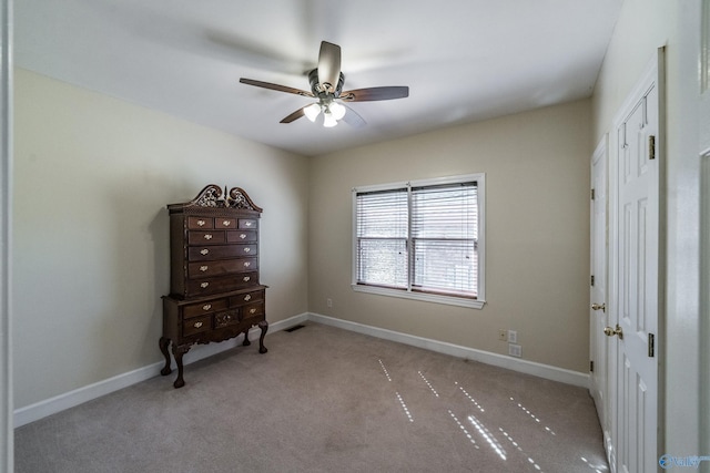 unfurnished bedroom featuring visible vents, a ceiling fan, baseboards, and carpet floors