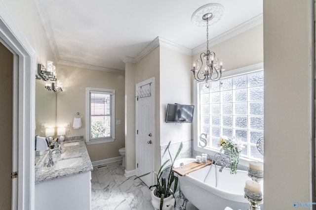 full bathroom with a sink, a freestanding bath, marble finish floor, and toilet