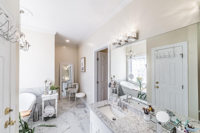 full bath featuring ornamental molding, an inviting chandelier, a freestanding tub, marble finish floor, and vanity