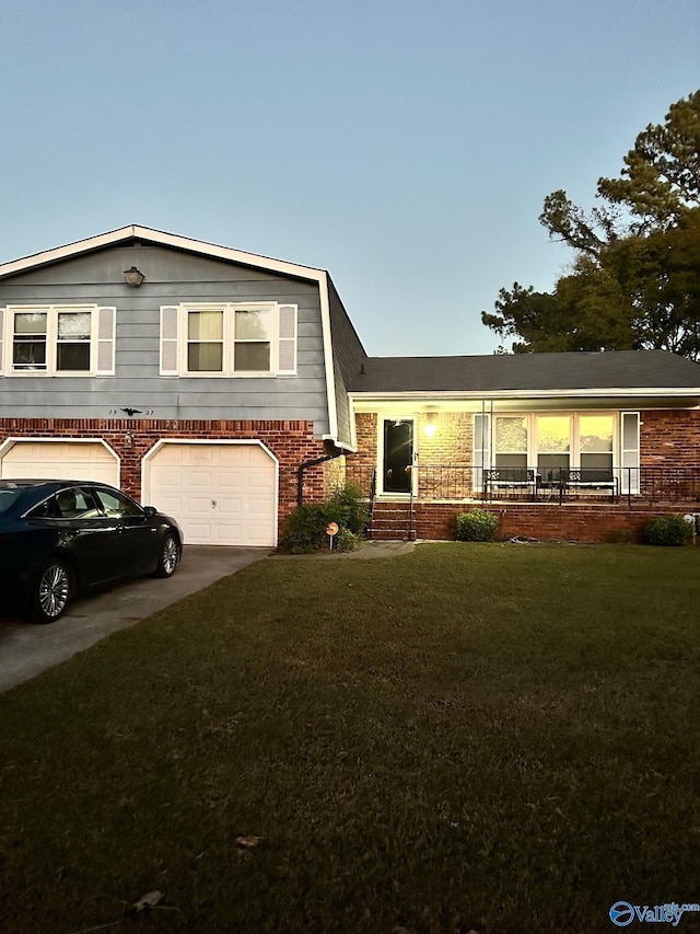 tri-level home with a yard and a garage