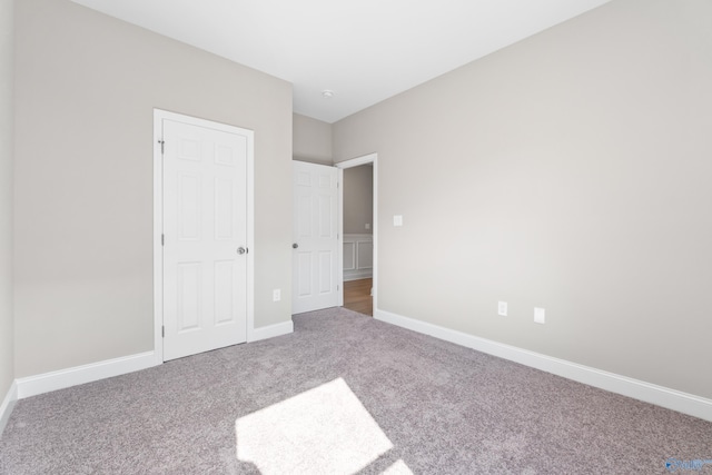 unfurnished bedroom with baseboards and carpet floors