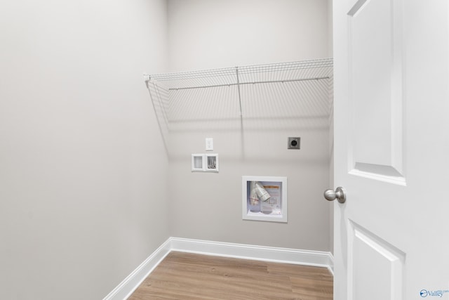 washroom featuring laundry area, light wood-style flooring, baseboards, and electric dryer hookup