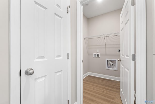 washroom with wood finished floors, baseboards, hookup for an electric dryer, hookup for a washing machine, and laundry area