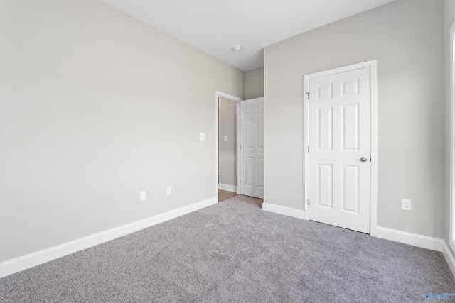 unfurnished bedroom with baseboards and carpet floors