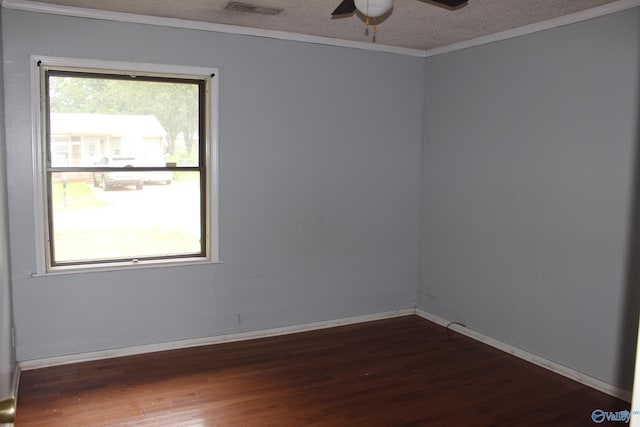 empty room with ceiling fan, a textured ceiling, plenty of natural light, and dark hardwood / wood-style floors