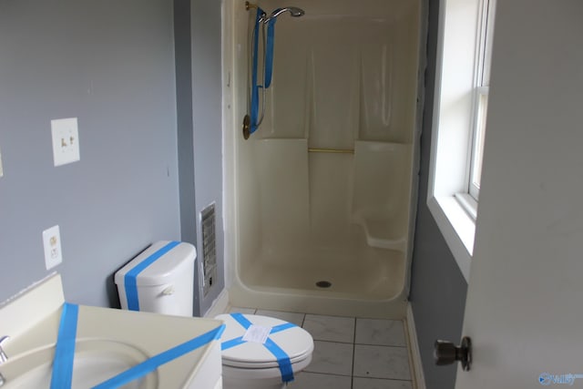 bathroom featuring a shower, vanity, toilet, and tile patterned floors