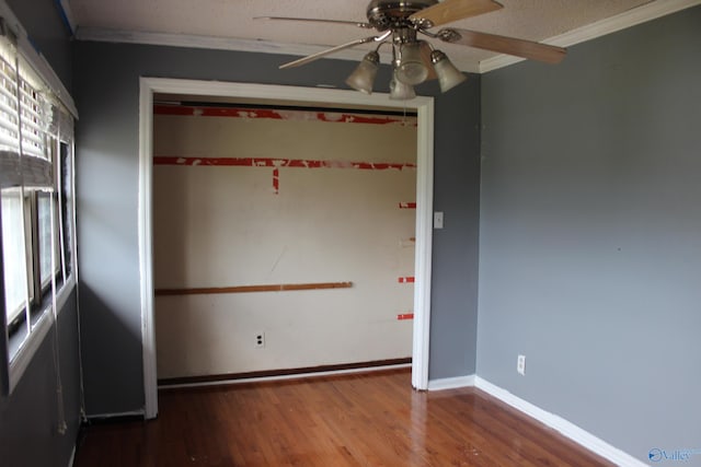 unfurnished room with ceiling fan, hardwood / wood-style flooring, crown molding, and a healthy amount of sunlight