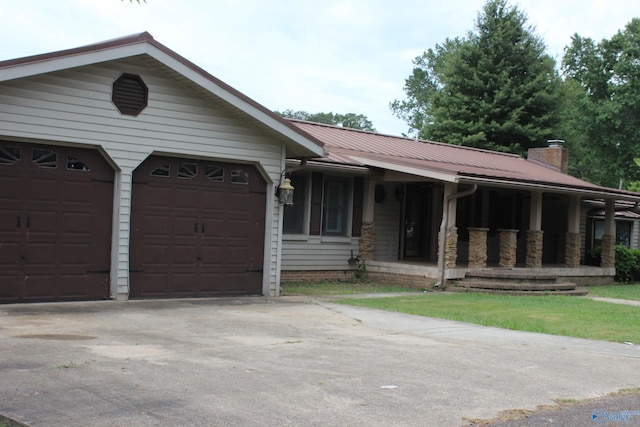 ranch-style home with covered porch and a garage