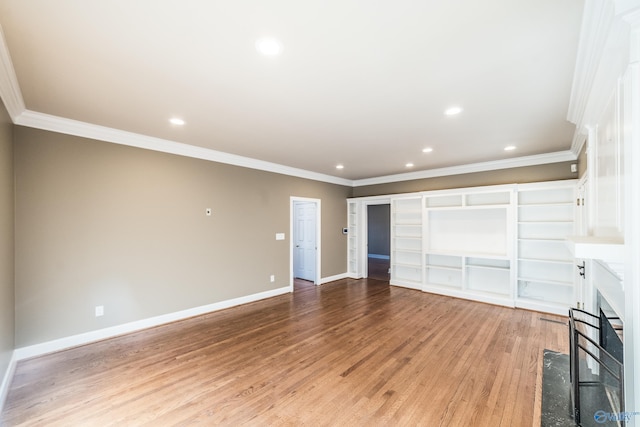 unfurnished living room with ornamental molding and light wood-type flooring