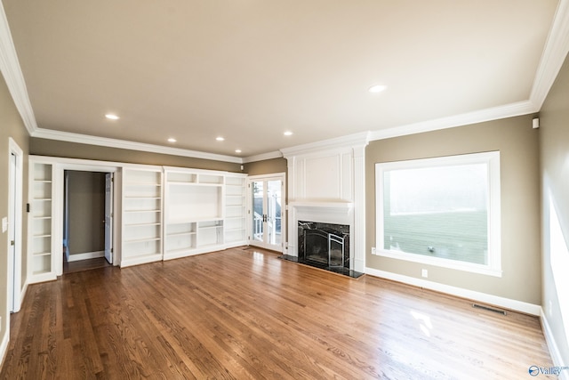 unfurnished living room featuring a large fireplace, light wood-type flooring, and crown molding